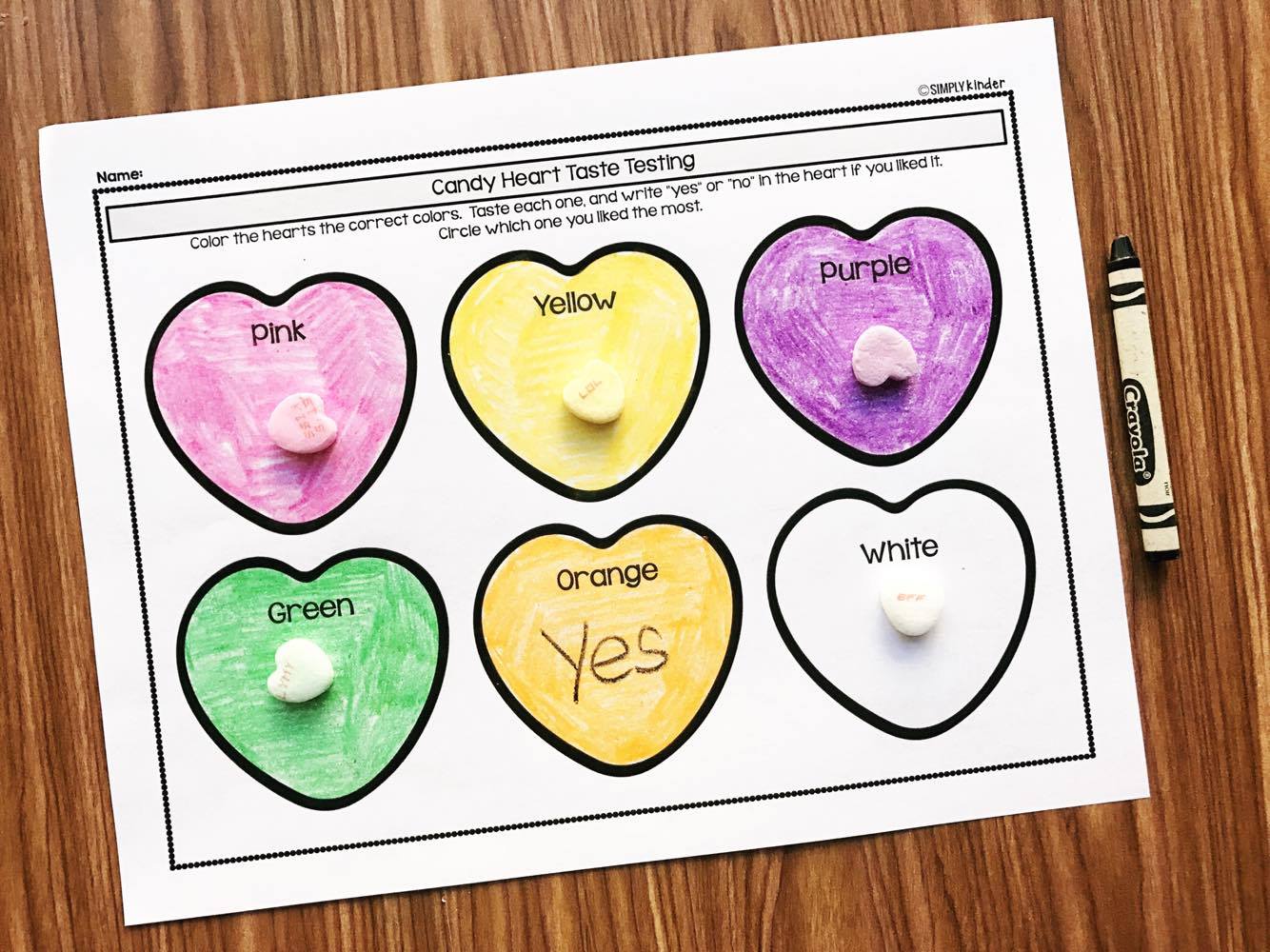 Taste testing different color conversation hearts.  A great Valentine's Day science project for preschool, kindergarten, and first grade.